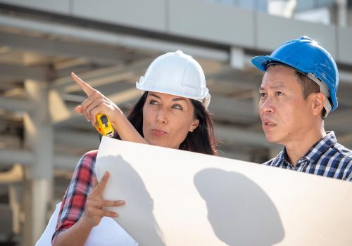 engineer-woman-is-pointing-for-project-manager-to-see-building_t20_axQ2rp